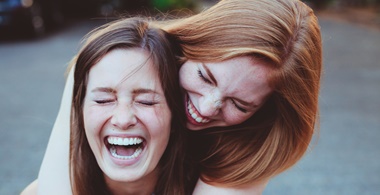 Zwei Mädchen lachen herzhaft